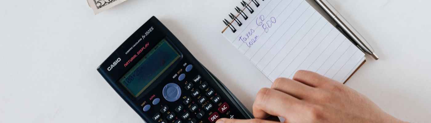 crop faceless accountant using calculator while making budget
