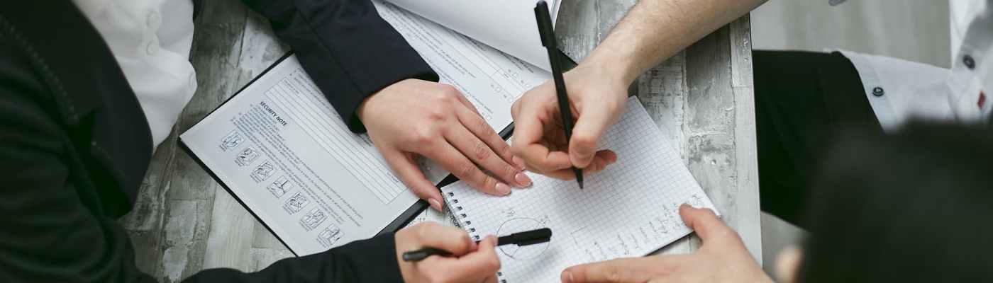 person writing on white paper