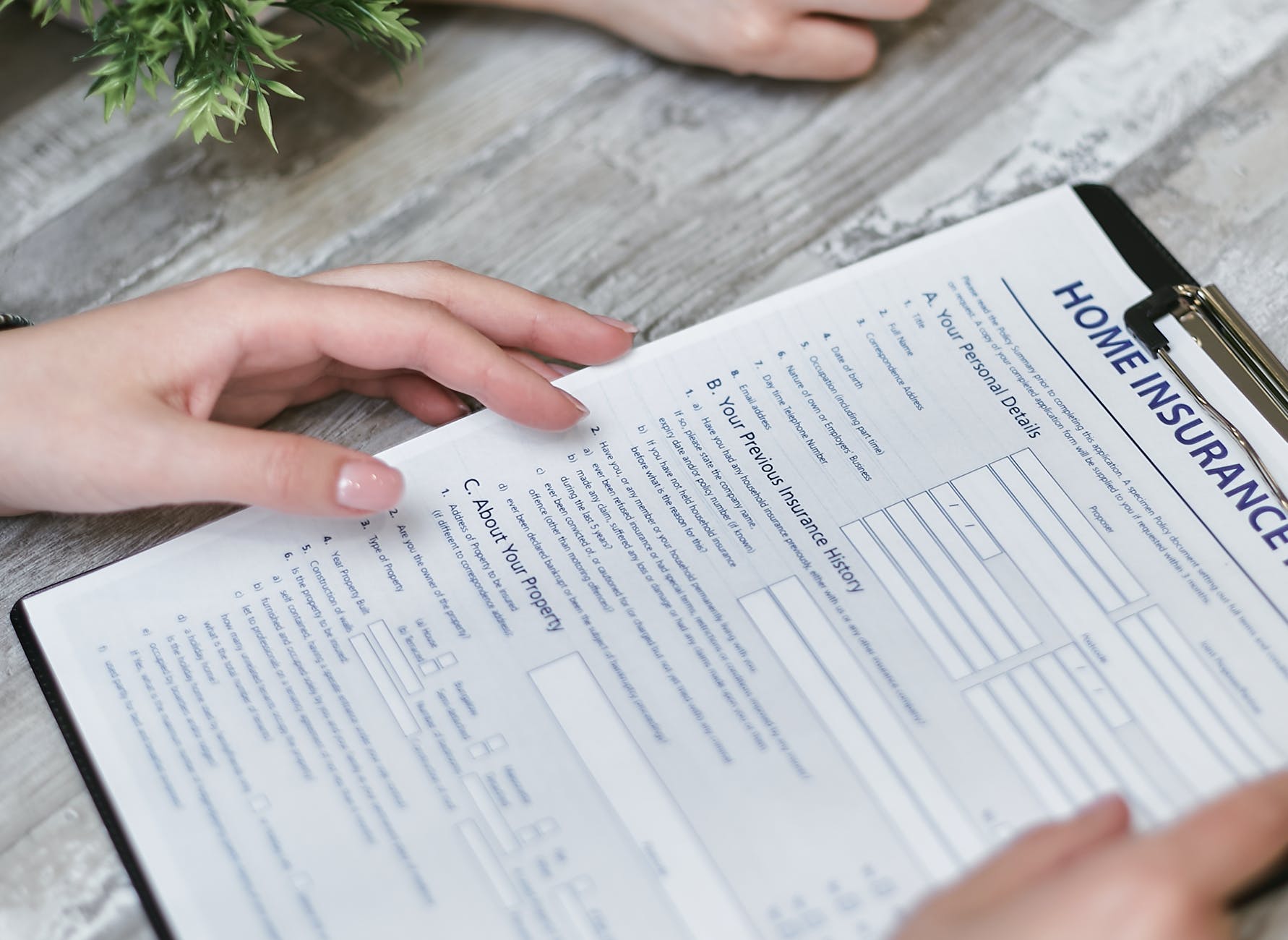 person holding home insurance form