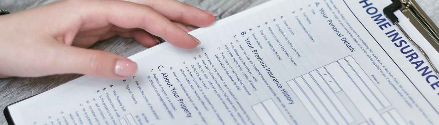 person holding home insurance form