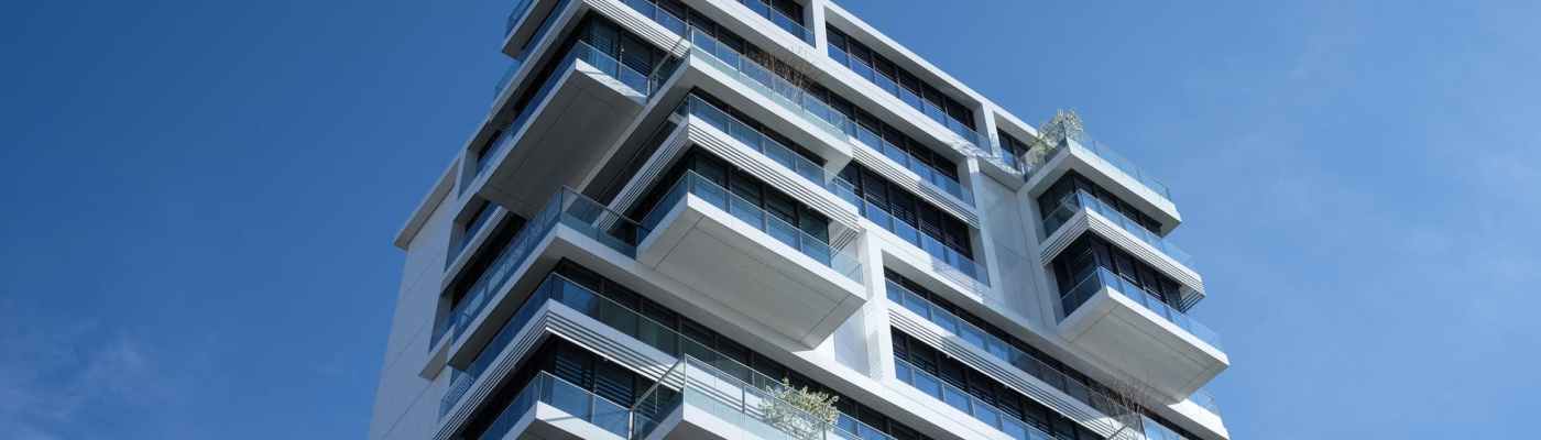 white concrete building under sunny blue sky