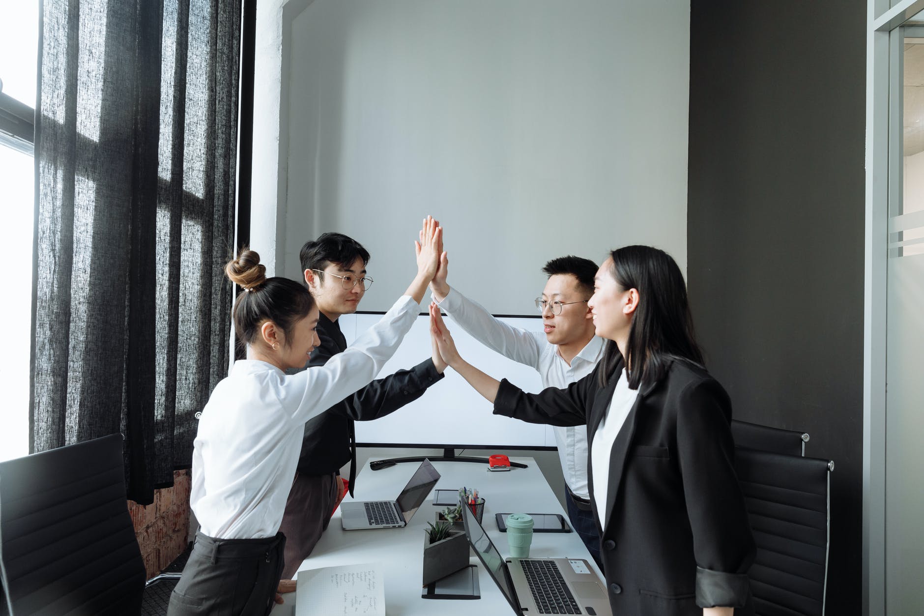 a group of people having a meeting in the office