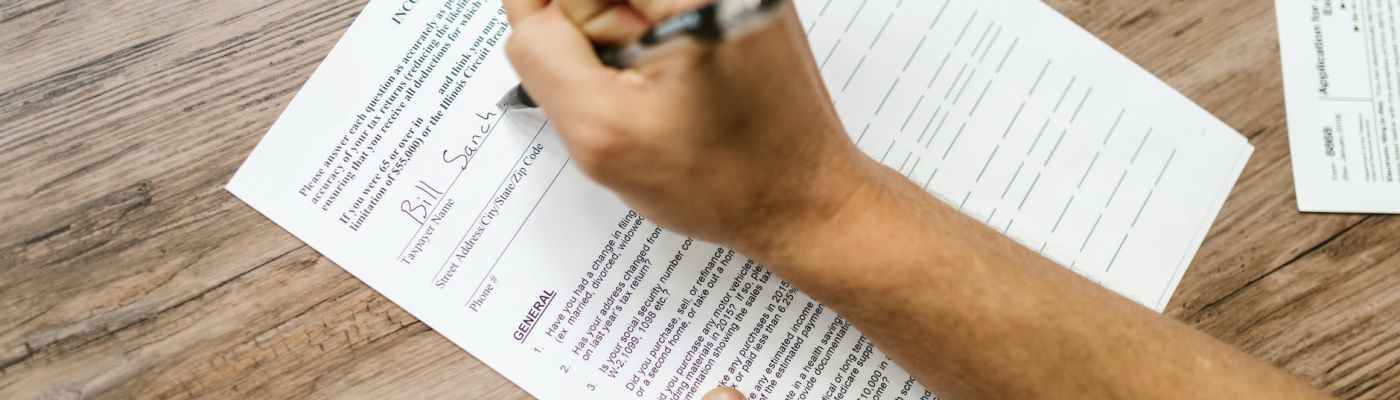 close up shot of a person filling out a questionnaire