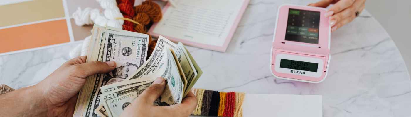 hands holding us dollar bills