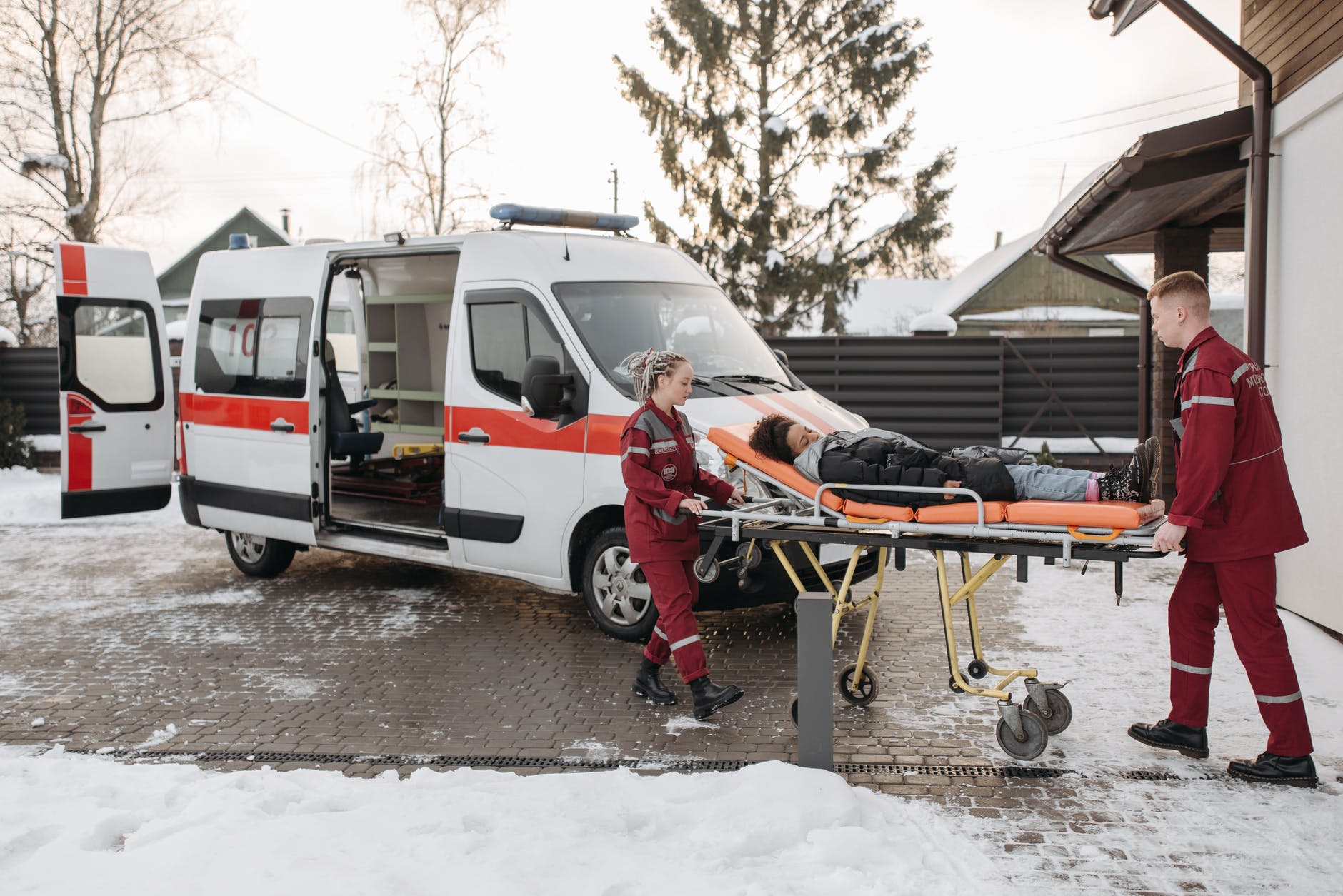 emt pushing woman on a stretcher
