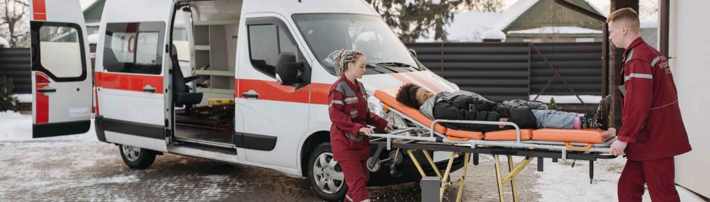 emt pushing woman on a stretcher